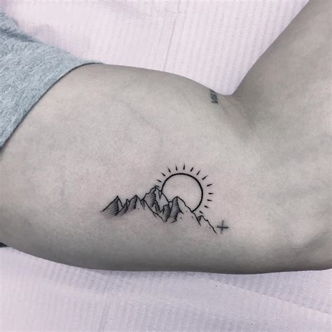 mountain tattoo meaning|mountains with sun tattoo.